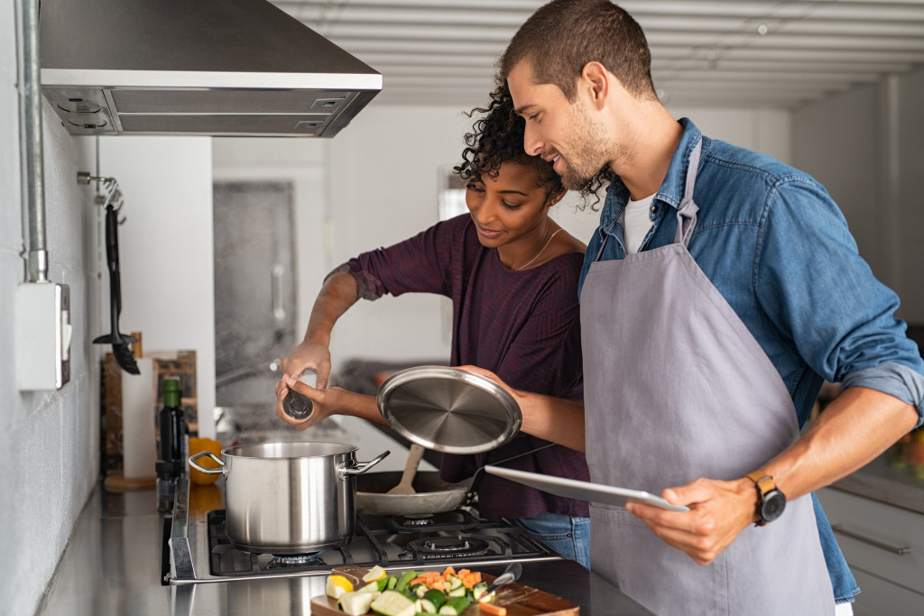 A couple cooking together in the kitchen