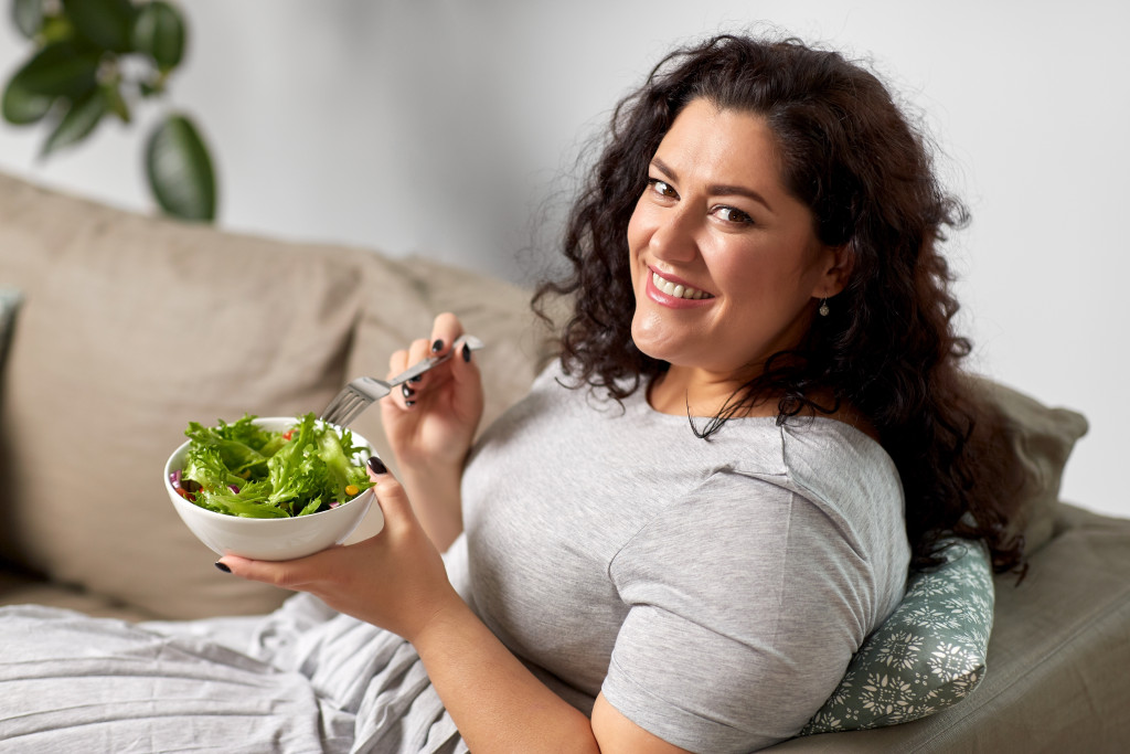 diet concept; woman eating vegetable salad